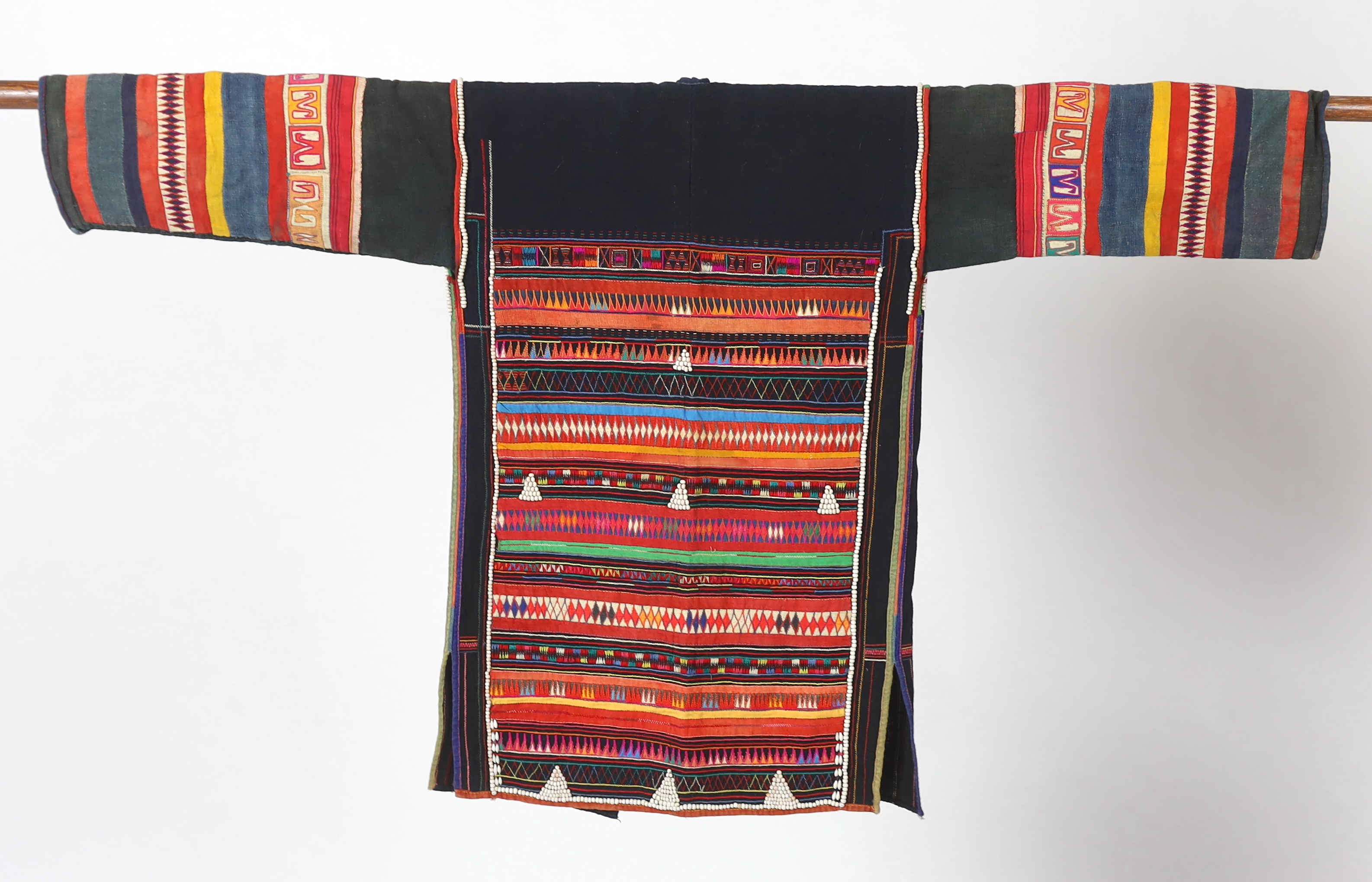 A Chiang Mai (Thailand) embroidered ladies three quarter length jacket, embroidered in hand dyed polychrome threads, (HKHA jacket) with beaded borders and spot design on a hand woven linen, 79cm long from neck to base